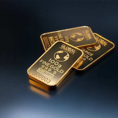 Three Gold Bars Against Dark Background